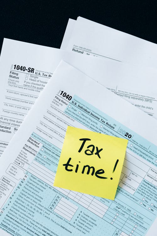 Tax documents and IRS forms on desk - guide to responding to IRS CP2000 notices